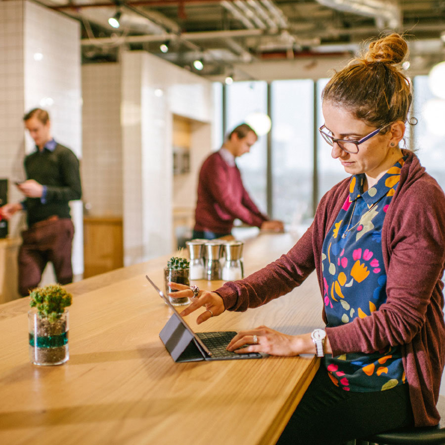 Woman working on smart device in the central working space